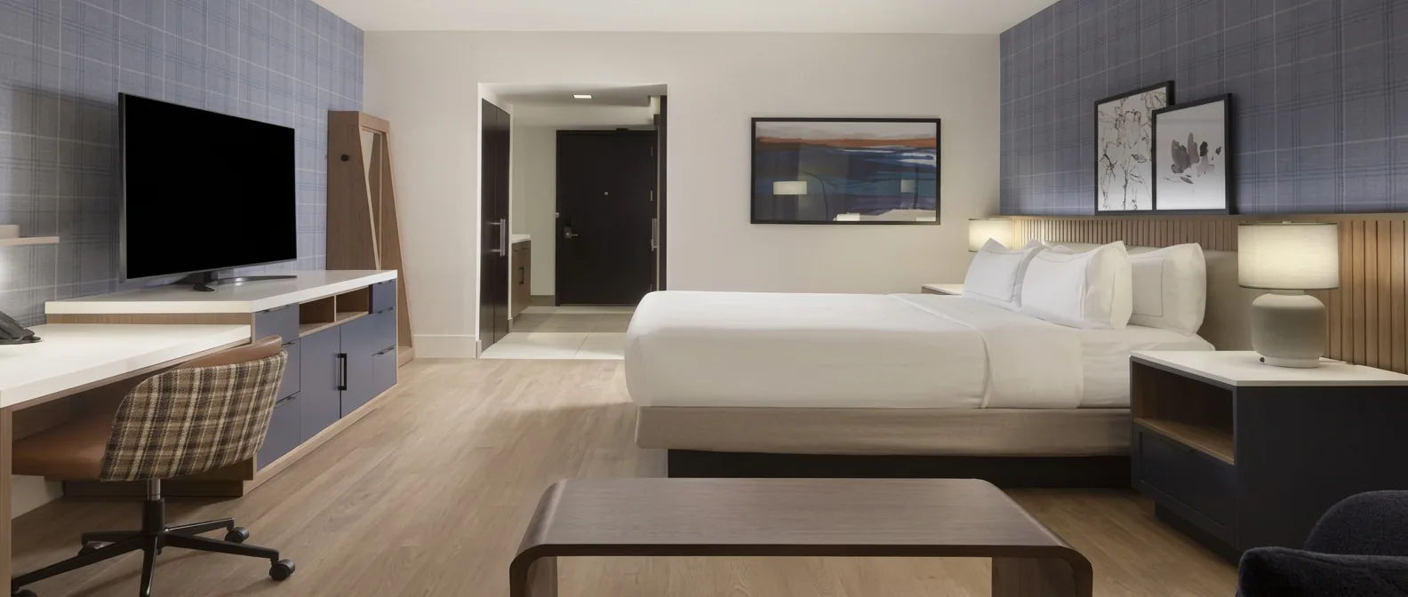 Hilton Granite Park guestroom with light wood casegoods and work desk